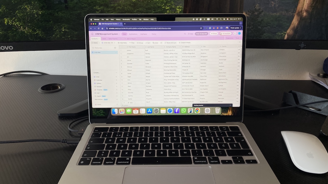 Airtable grid view on laptop screen showing structured contact and lead data for customizable CRM management